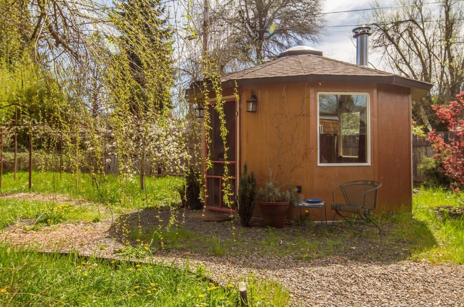 round home surrounded by plants and trees