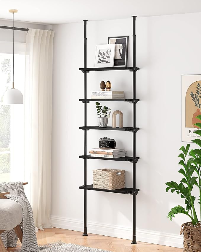 floor to ceiling black shelf with books and photos on it