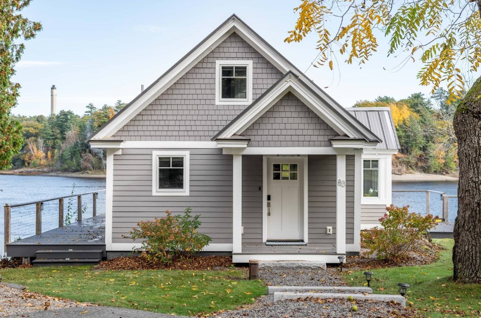 exterior of a home with gray walls near the lake