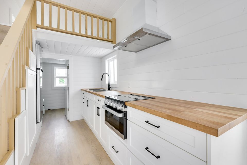 kitchen with brown cabinets, wooden countertop and a window