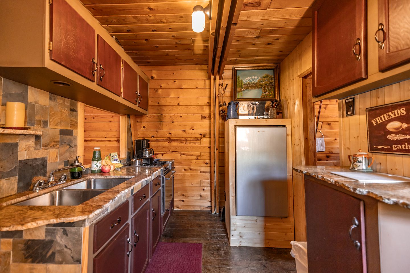 kitchen with brown cabinets and countertops on both sides of the room