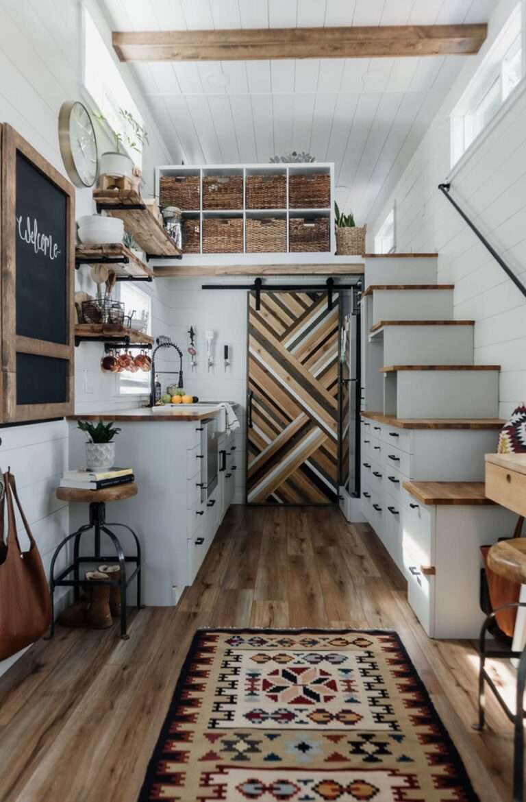 kitchen with white cabinets, brown countertop, stairs opposite the kitchen with drawers and open cabinets inside