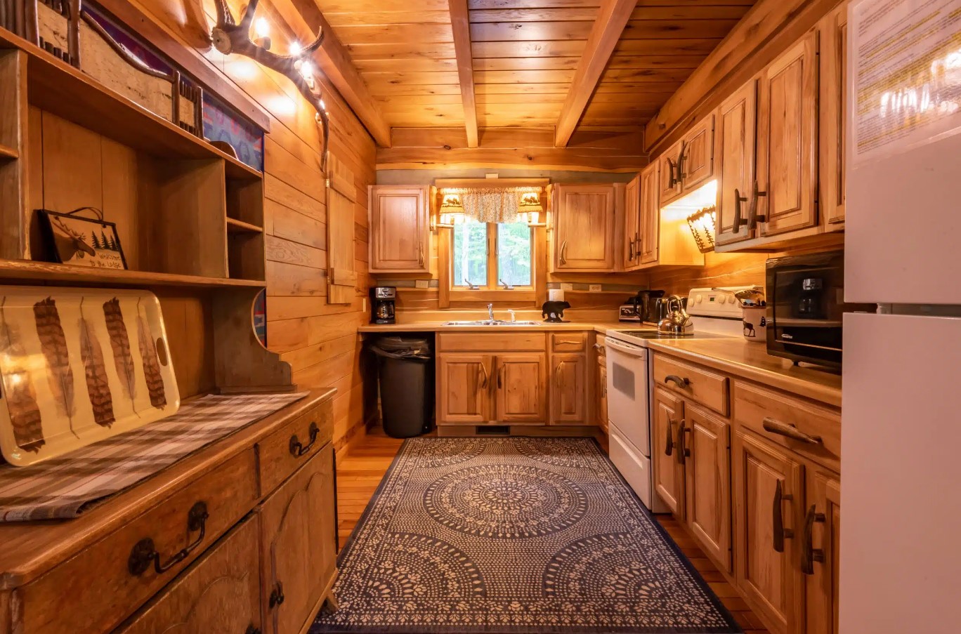 kitchen with wooden walls, wooden cabinets and wooden countertops