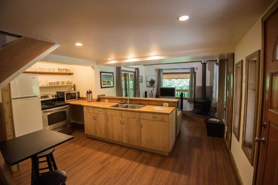 kitchen with a wooden cabinet, wooden countertop, wooden shelves, connected to the living room