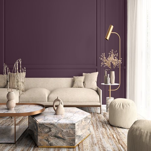 living room with a purple basil wall, light beige couch, two tables, tall lamp and a mini table next to the couch