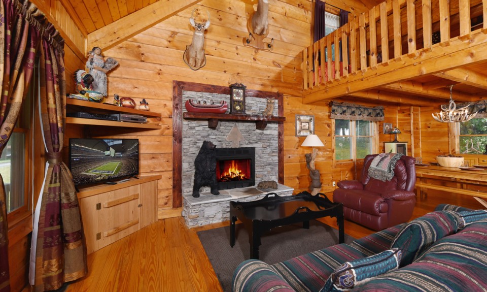 Living room with a funky couch and a stone fireplace