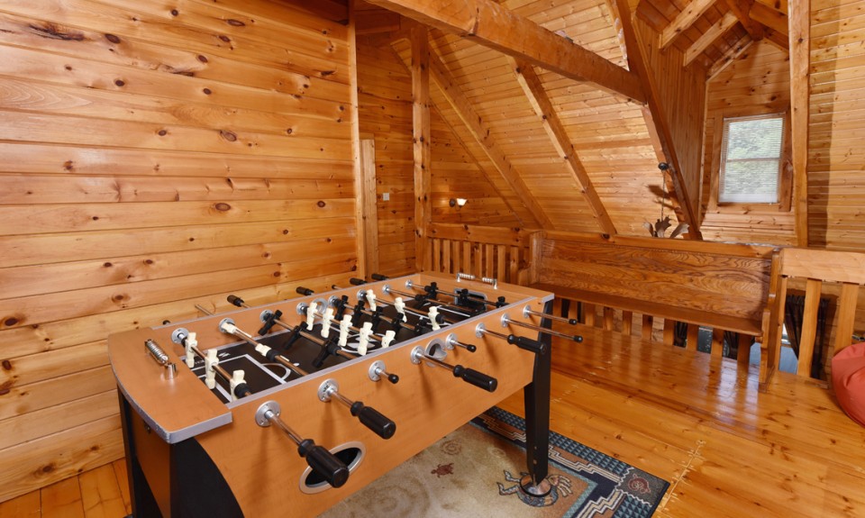 loft with games and a wooden bench