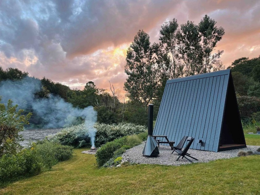 exterior of an a-frame cabin near the lake