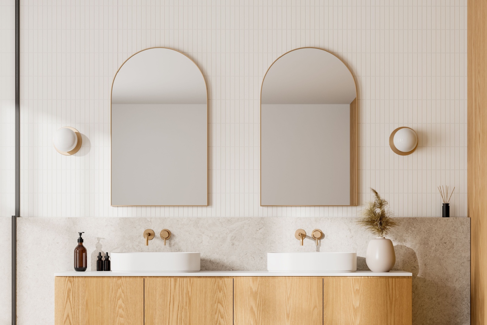 bathroom with mirrors with curved edges, two white sinks and a wooden cabinet