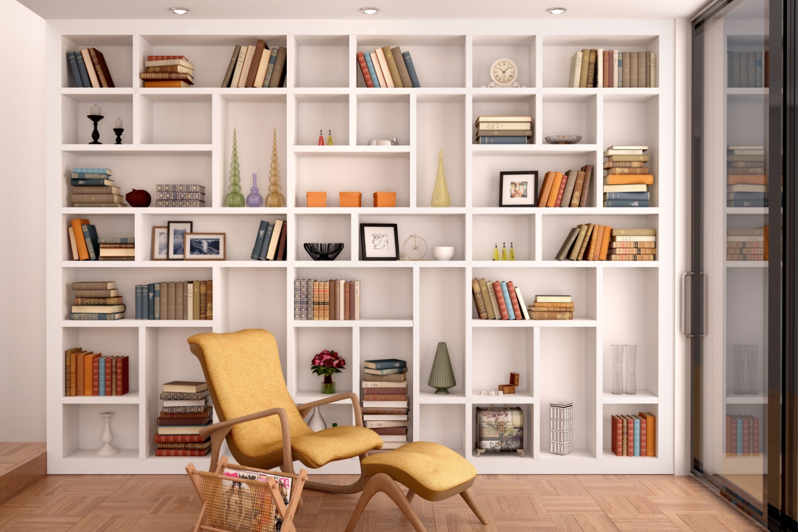 floor to ceiling shelf with books and other decor and a chair in front