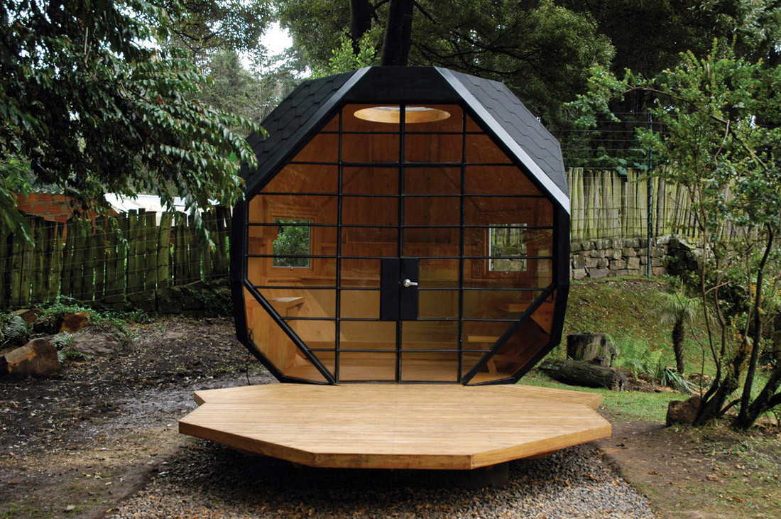 polyhedron tiny house with a terrace surrounded by greenery