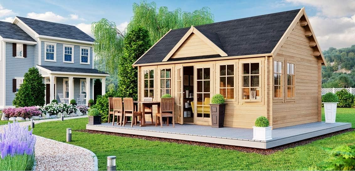 exterior of a home with wooden walls with a little terrace and an outdoors dining table with chairs