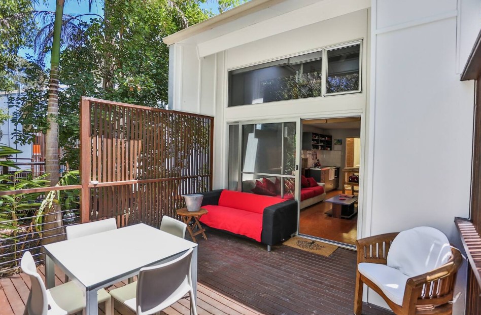 terrace of a container with a couch, white table and white chairs