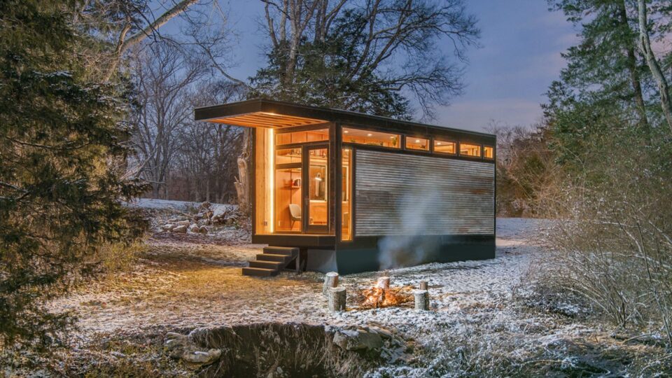 exterior of a tiny home with warm lightning in the woods