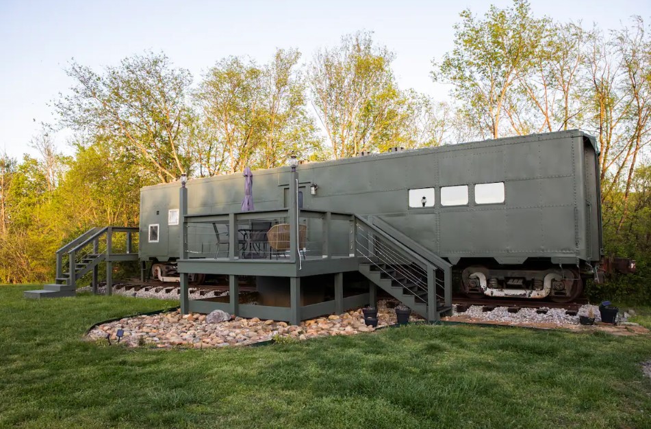 black exterior of a tiny home which used to be a world war two train