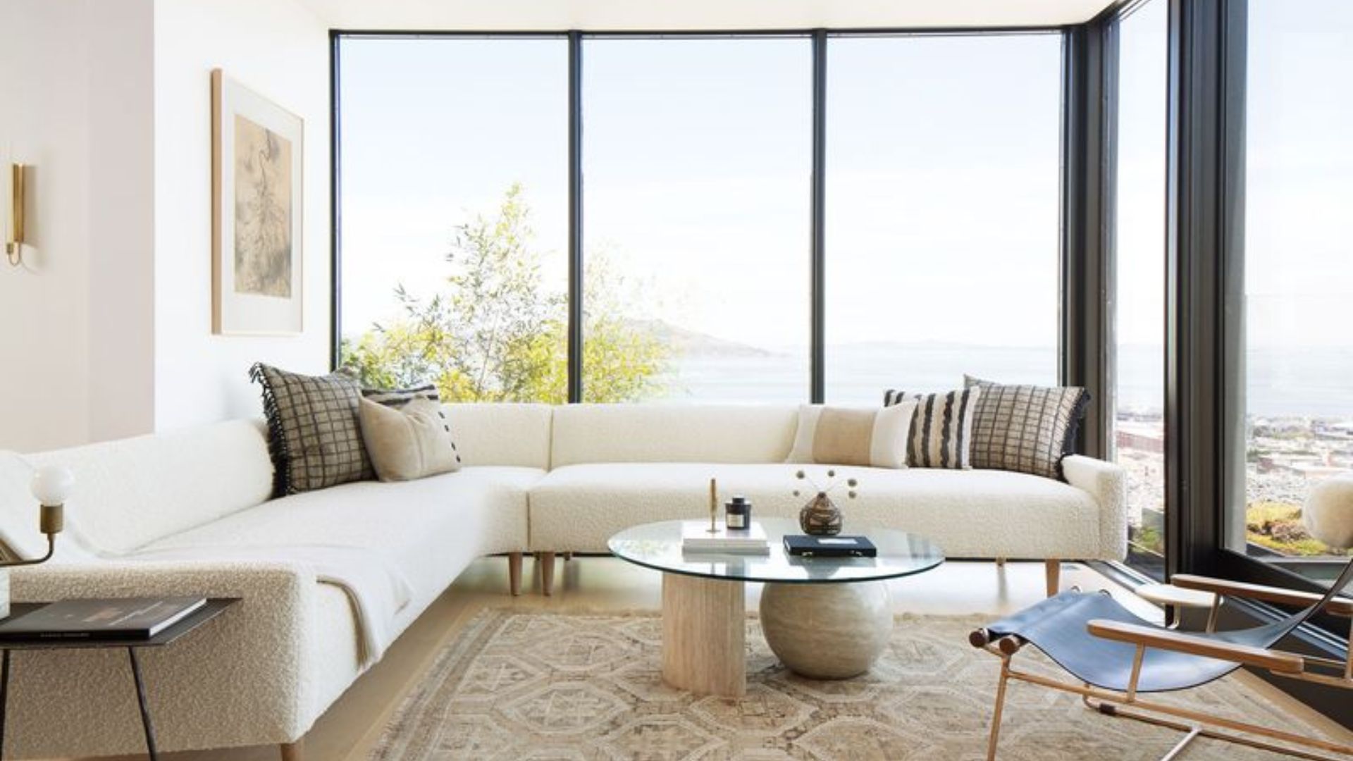 living room with a beige l-shaped couch and floor to ceiling windows