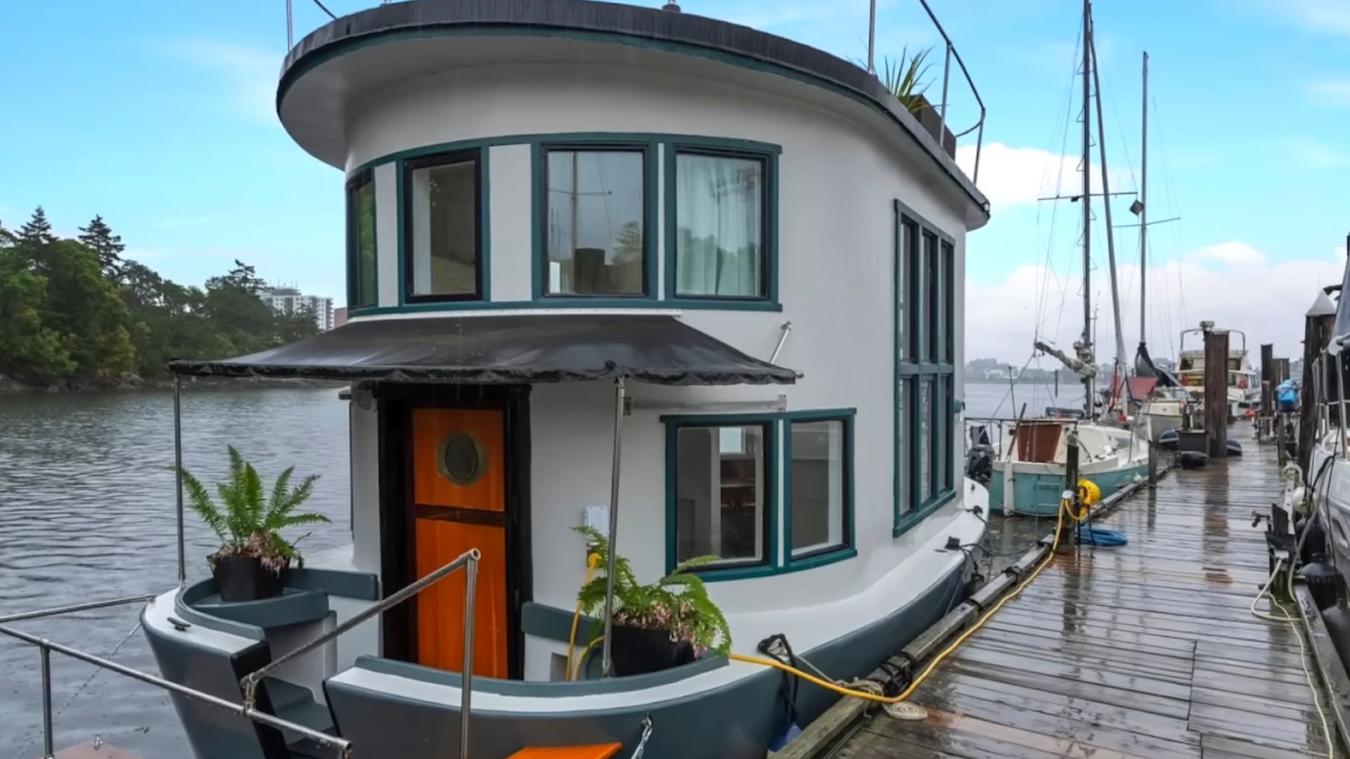 a round house with wooden door, white exterior, placed on a boat