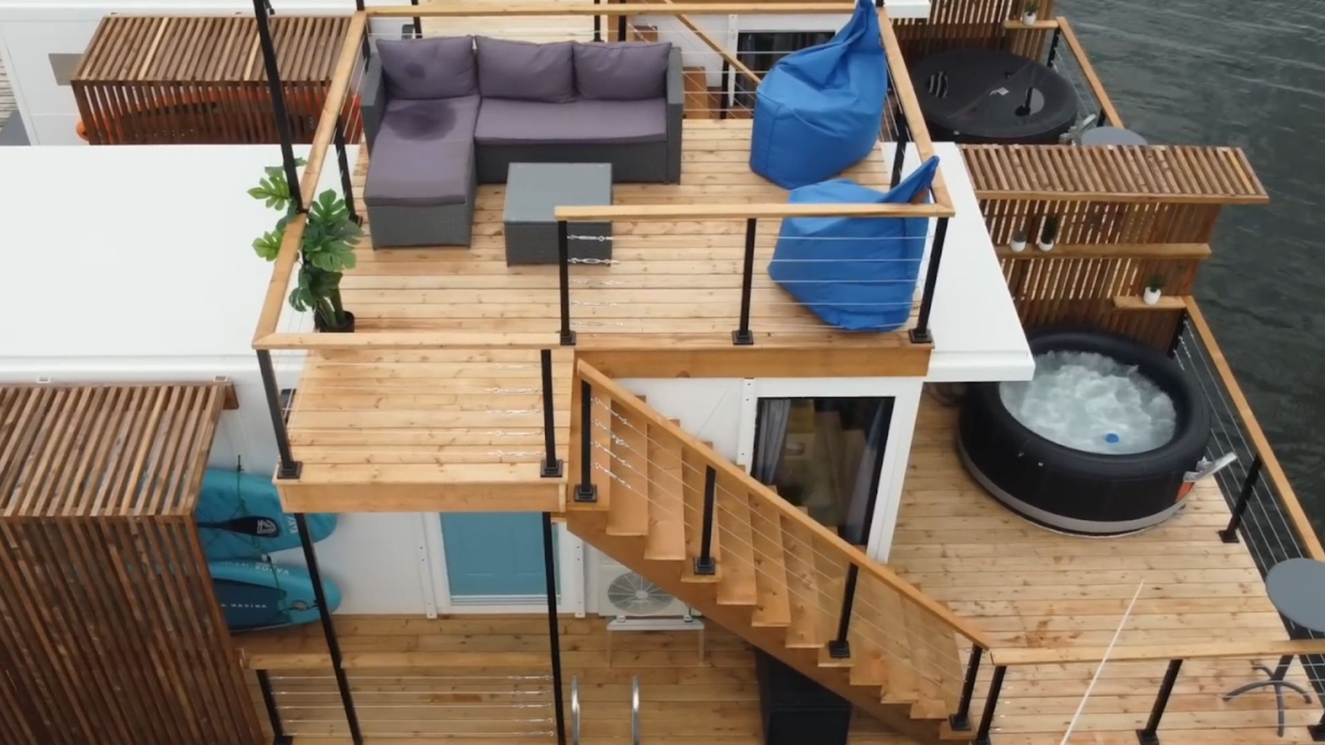 stylish and modern tiny house with a deck floating on water