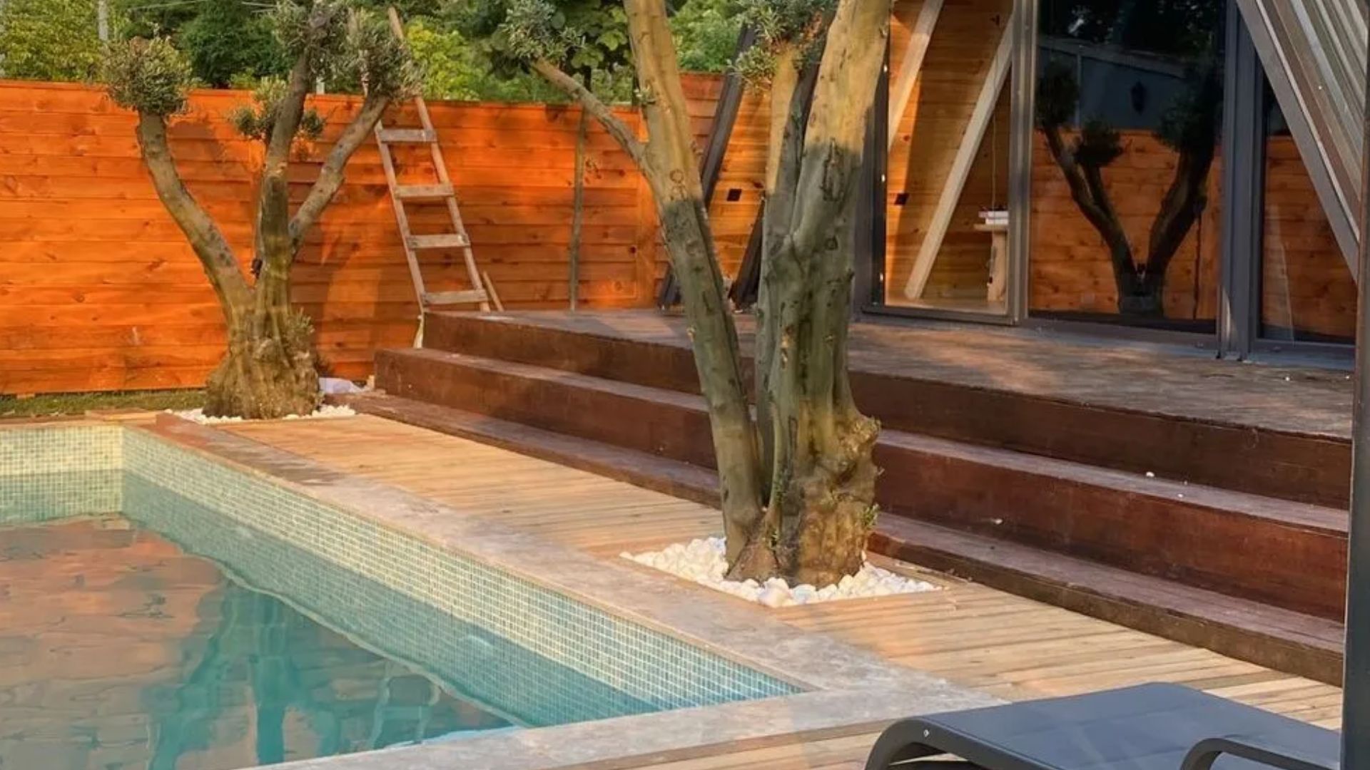 swimming pool next to tiny house