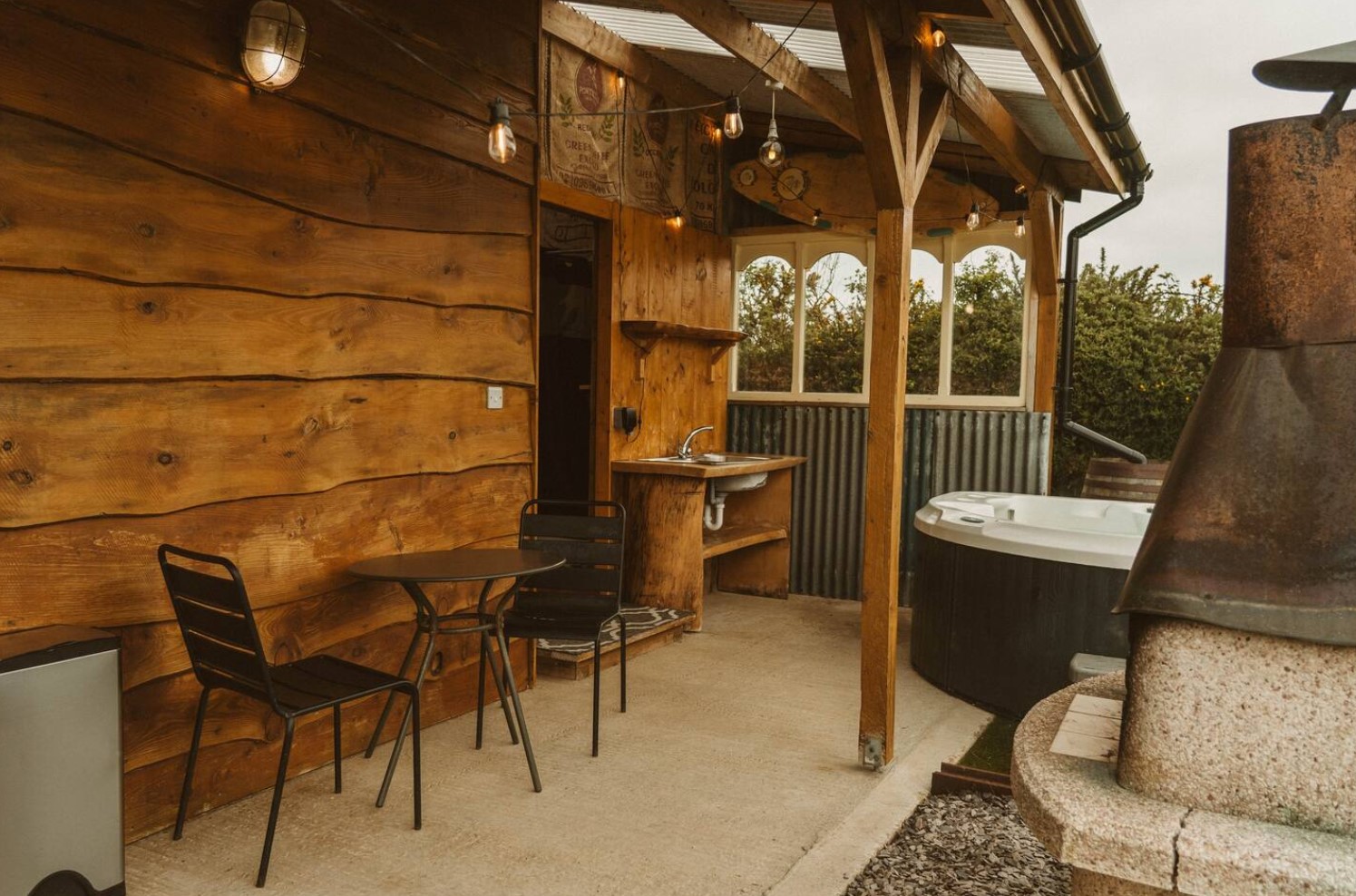 Backyard with hot tub, grill and lounge area