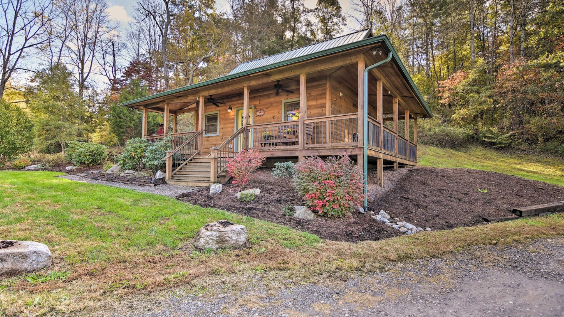 exerior of the brookside cabin with a porch and lots of greenery outside