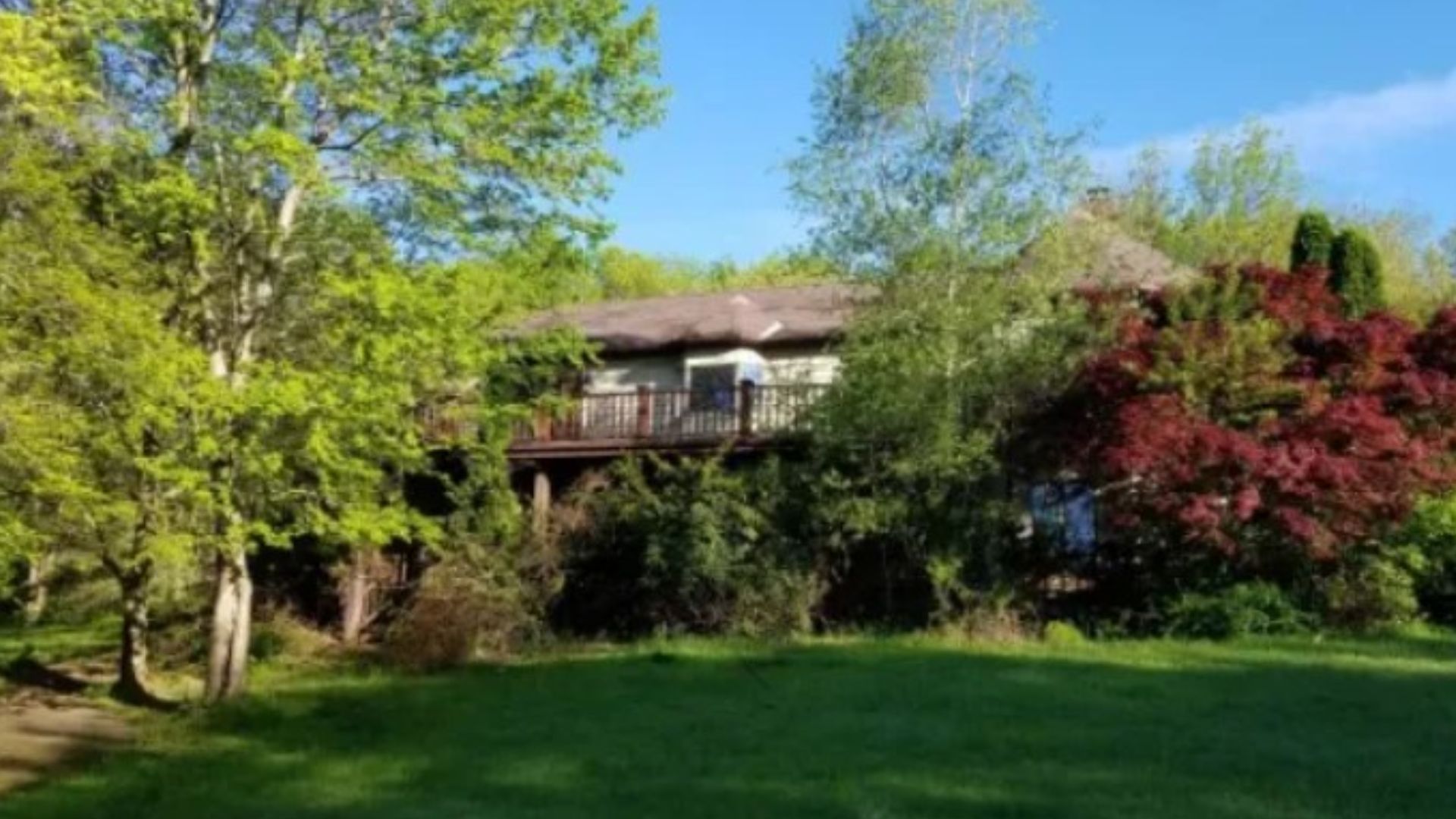 exterior of a big home with white walls and greenery