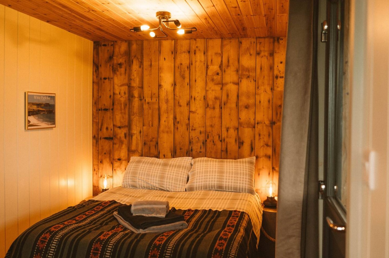 Cozy bedroom with wooden wall