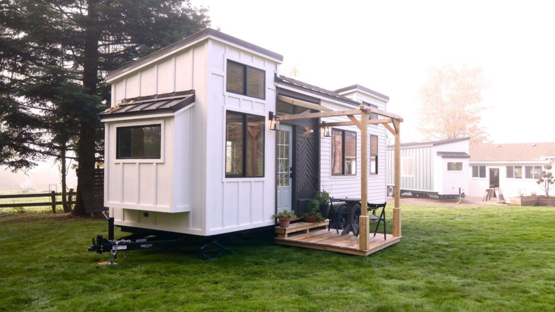 exterior of a tiny home with light blue door and a porch