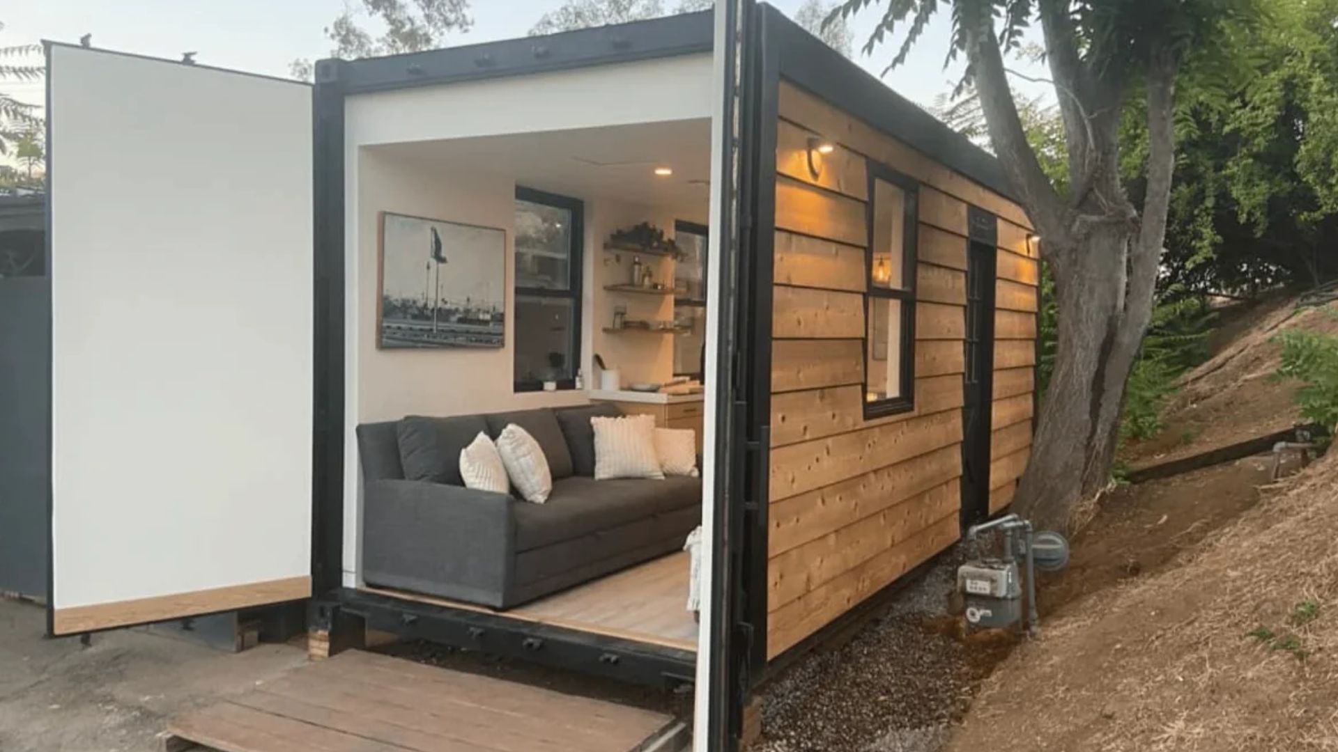 black container house with back door open