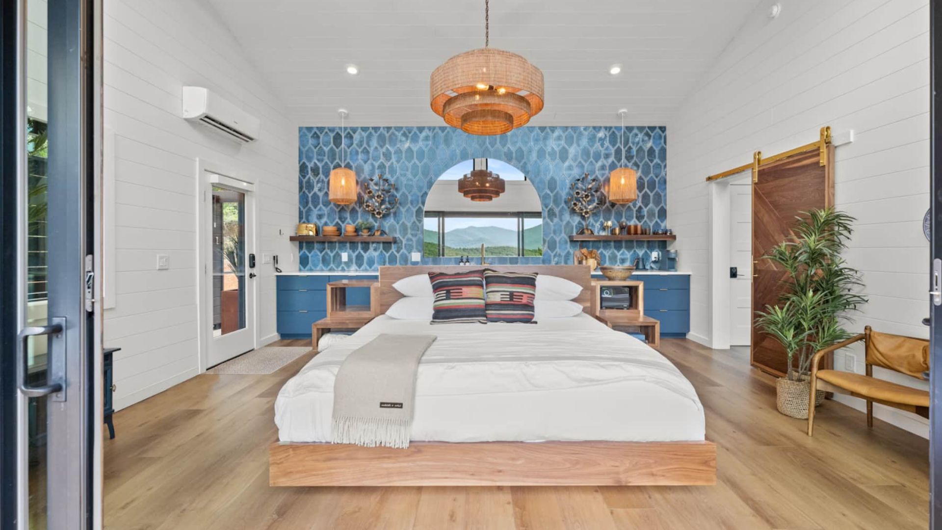 beautiful bedroom from the front side, kitchen in the back, lots of wooden and golden accents