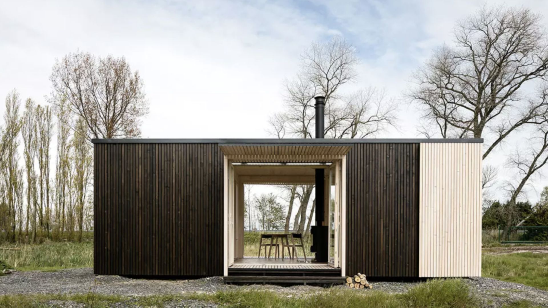 container house with dark exterior in a gass field