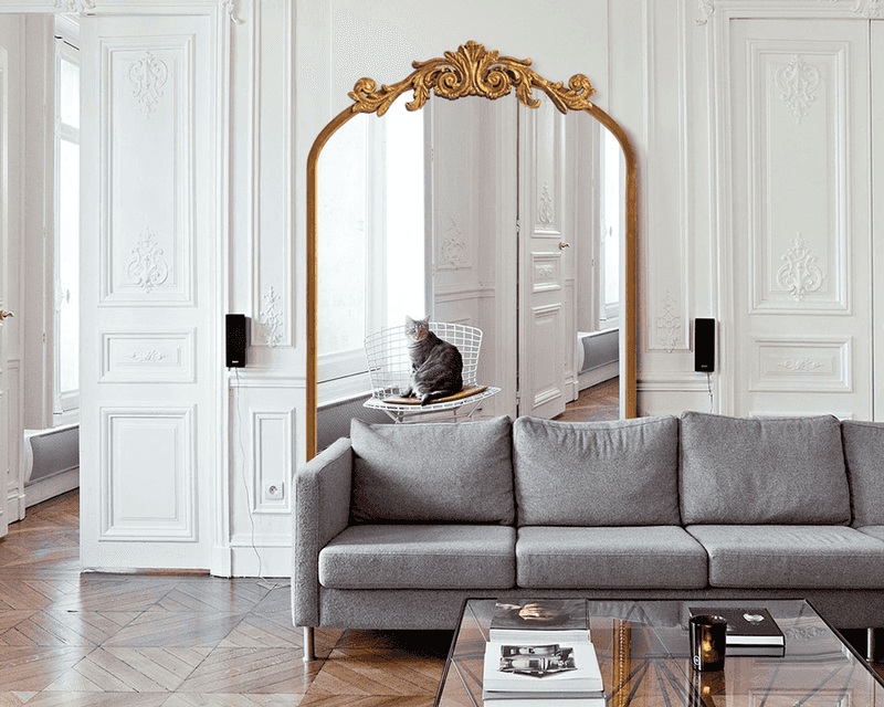 Gold mirror in a white room 