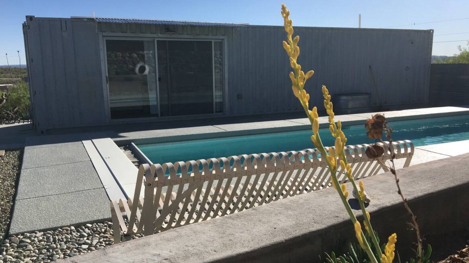 container house with a pool in the desert