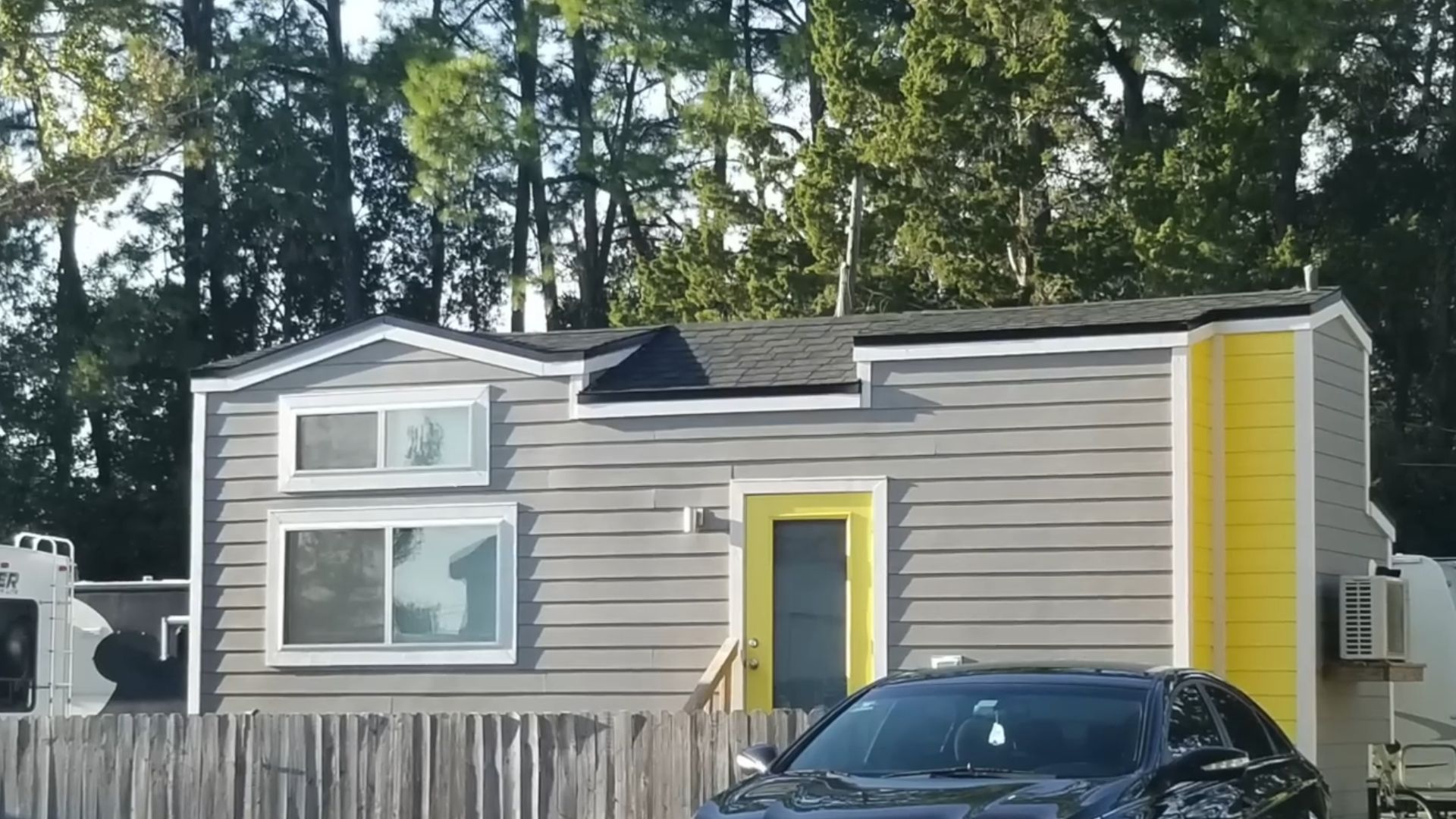 exterior of a tiny house with grey and yellow walls