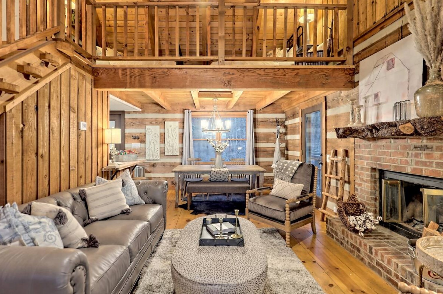 Living room with gray leather couch and a fireplace