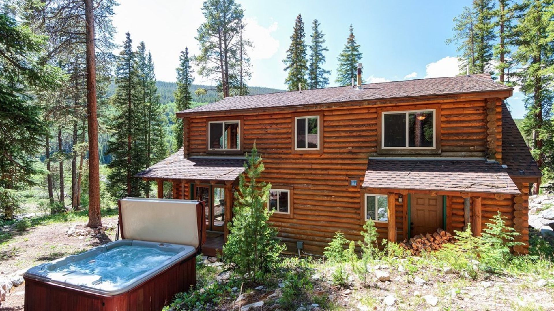 exterior of a brown, wooden cabin in the mountains