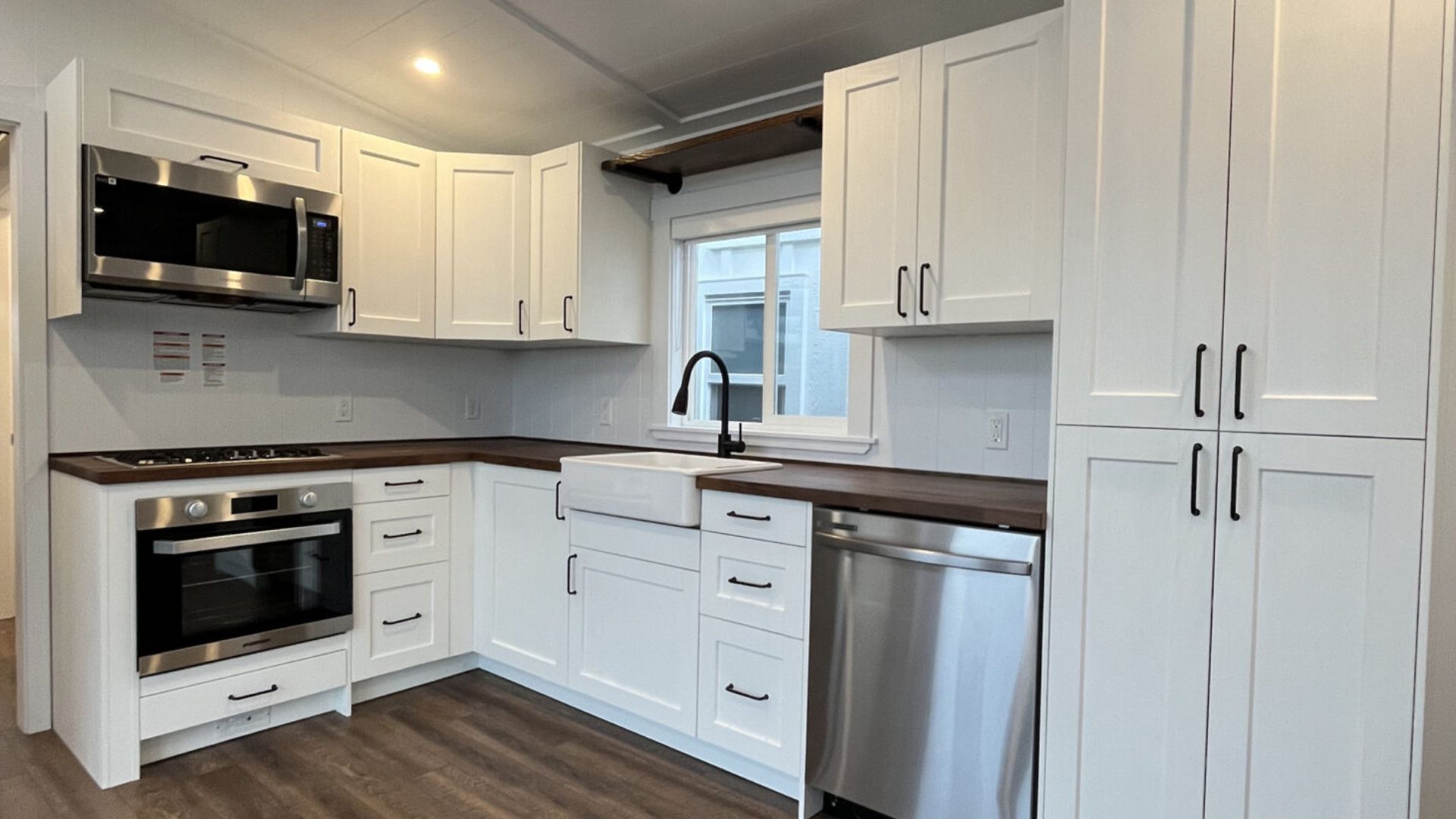 lovley white kitchen with darkwood countertops