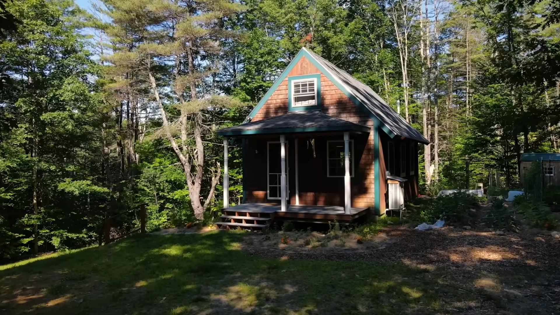 exterior of a cabin with brown walls in the woods