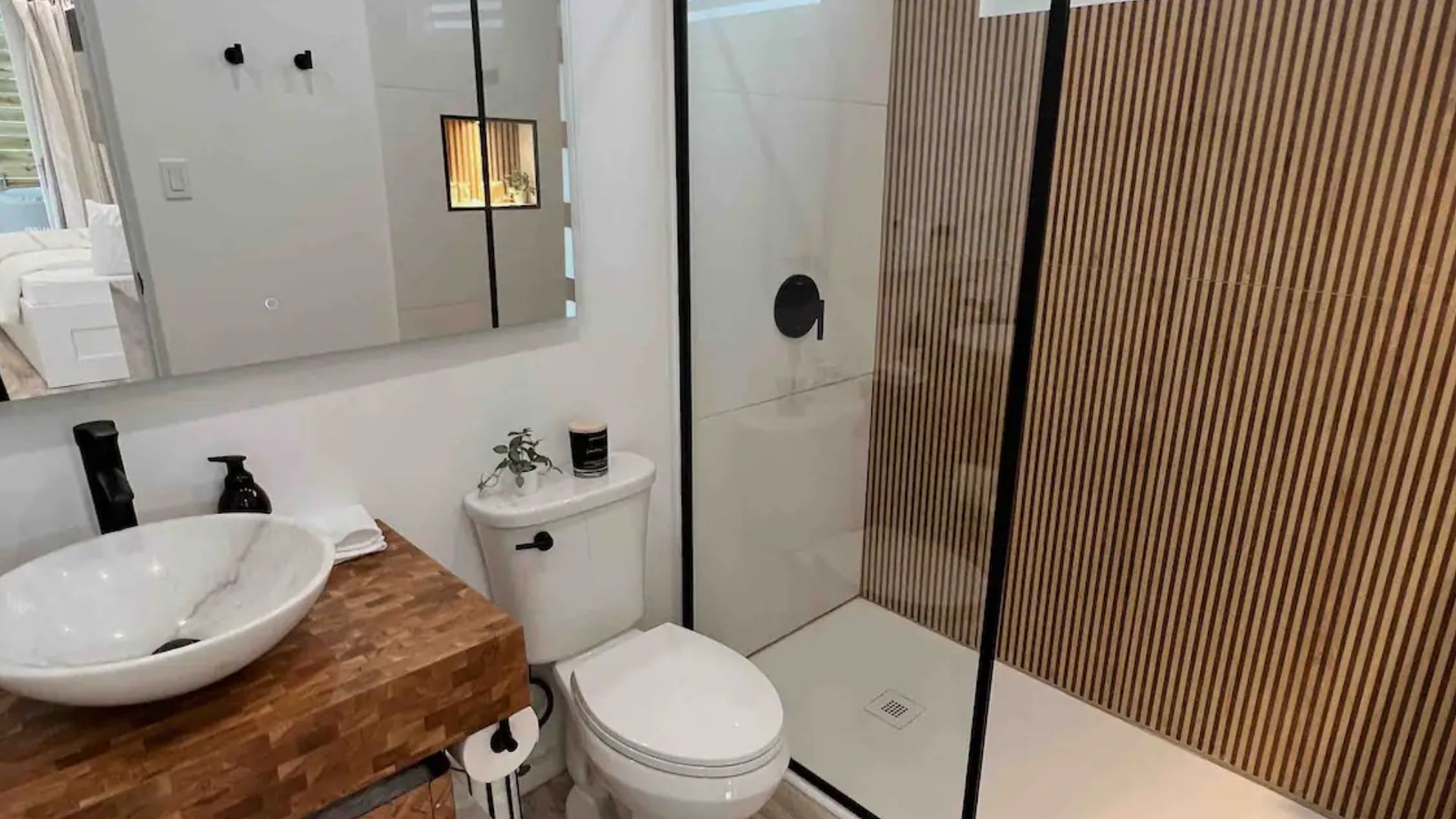 modern bathroom with a walk-in shower and a unique vanity