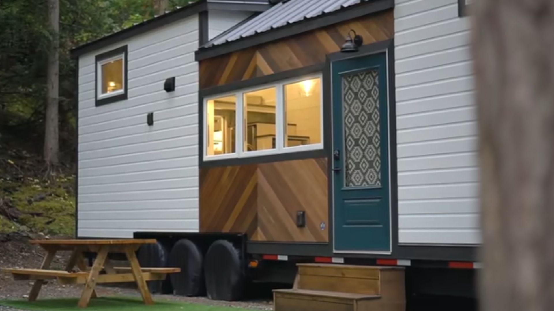 exterior of a tiny house on wheels with brown and white walls