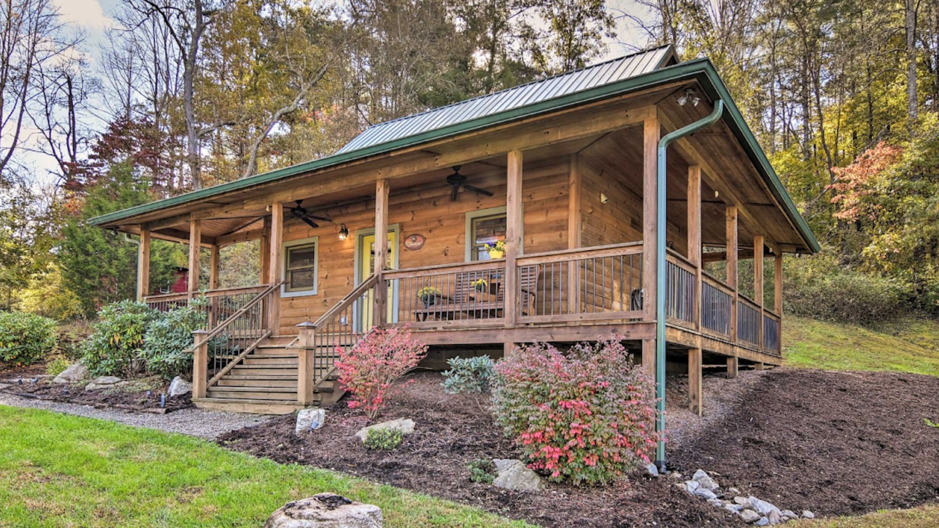 exerior of the brookside cabin with a porch and lots of greenery outside