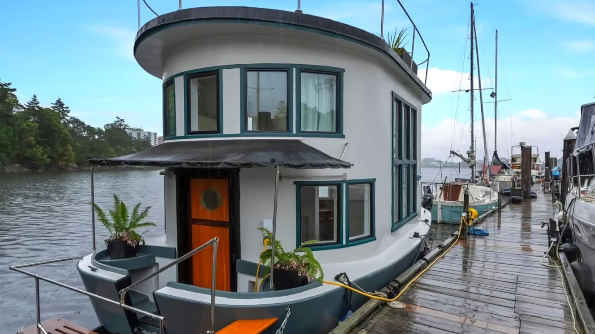 a round house with wooden door, white exterior, placed on a boat