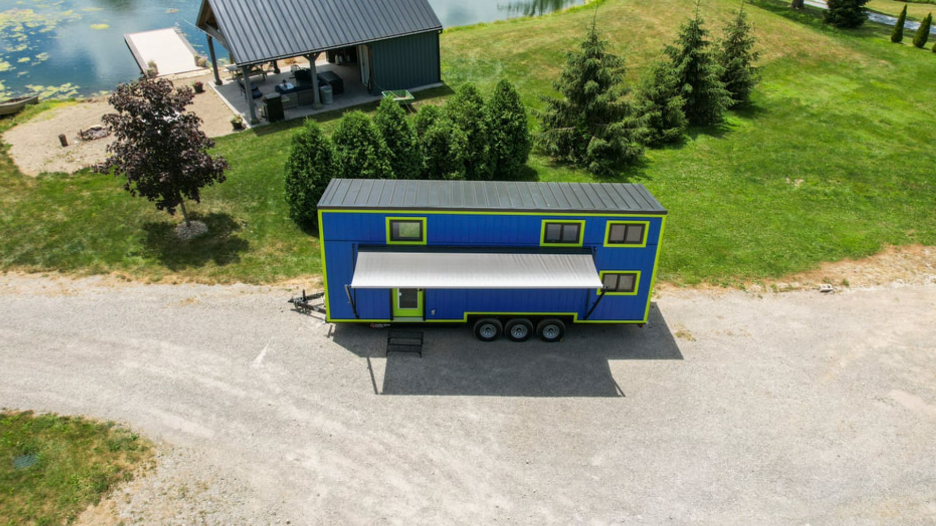 exterior of a blue tiny home on wheels