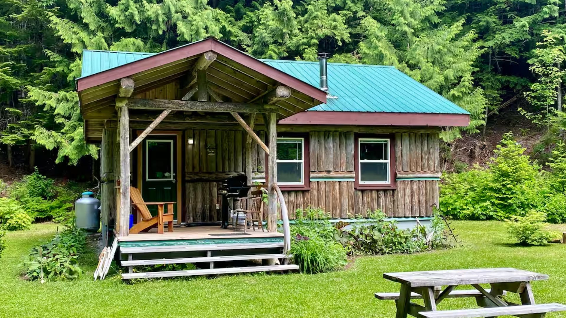 log cabin with a green roof