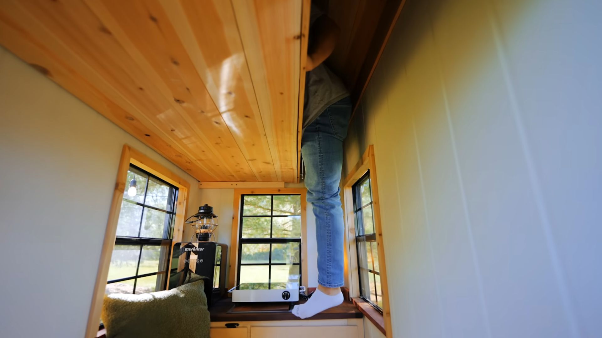 man climbing the tiny loft