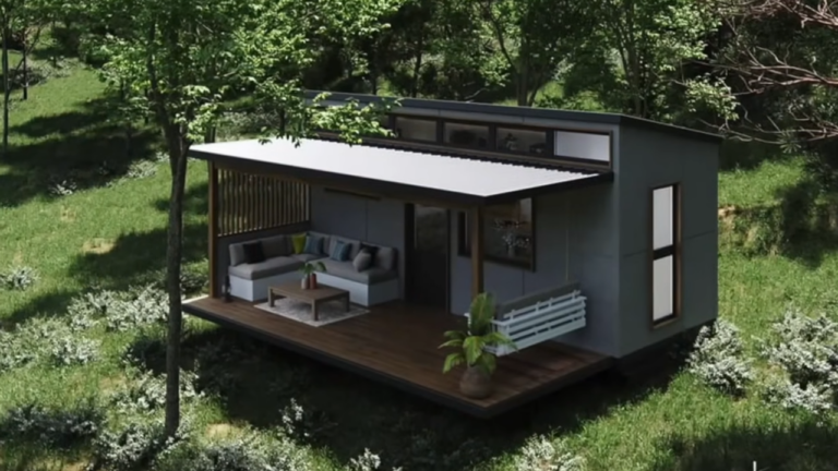 exterior of a tiny house with gray walls, surrounded by greenery