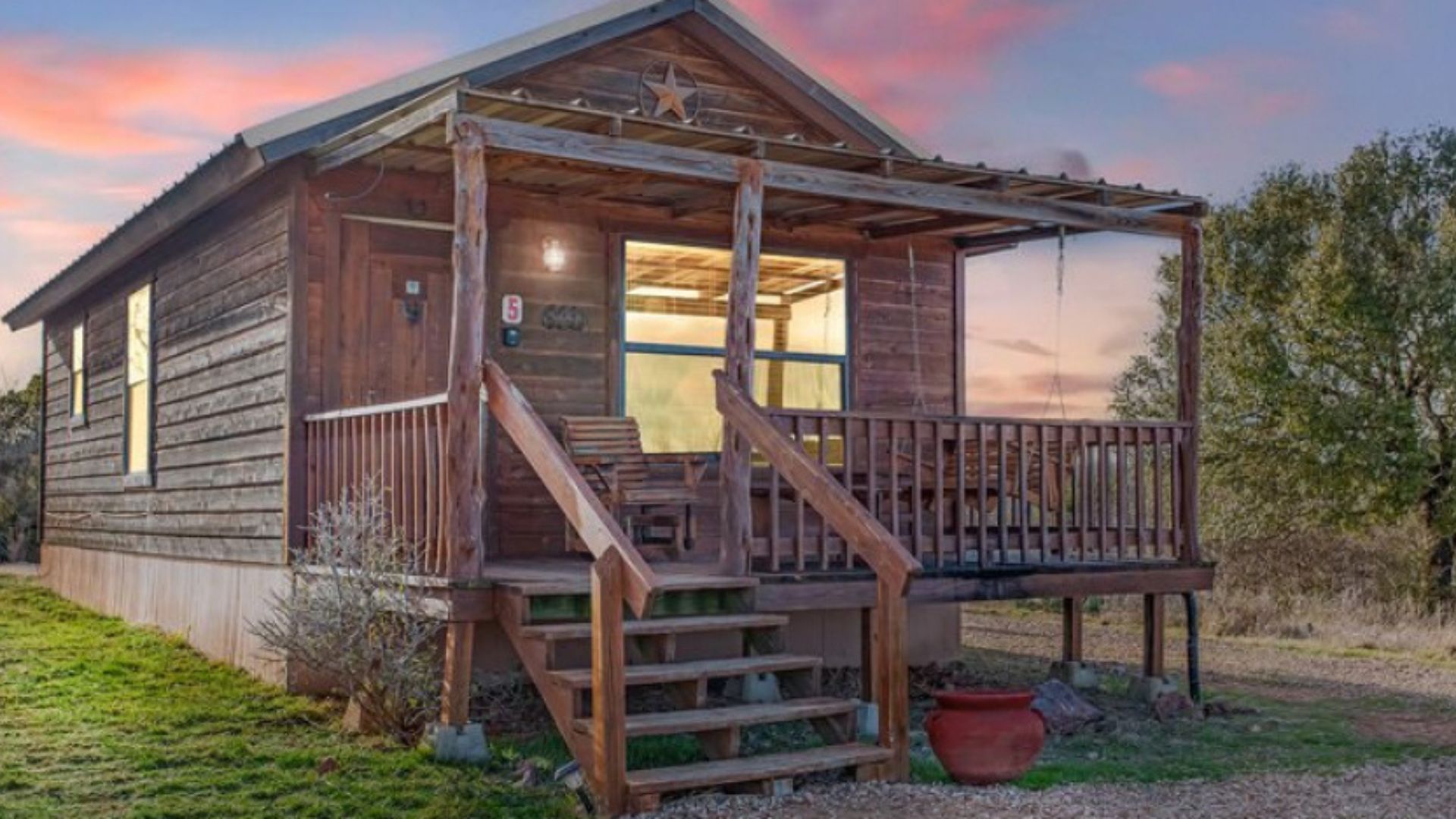 exterior of a wooden cabin during a sunset