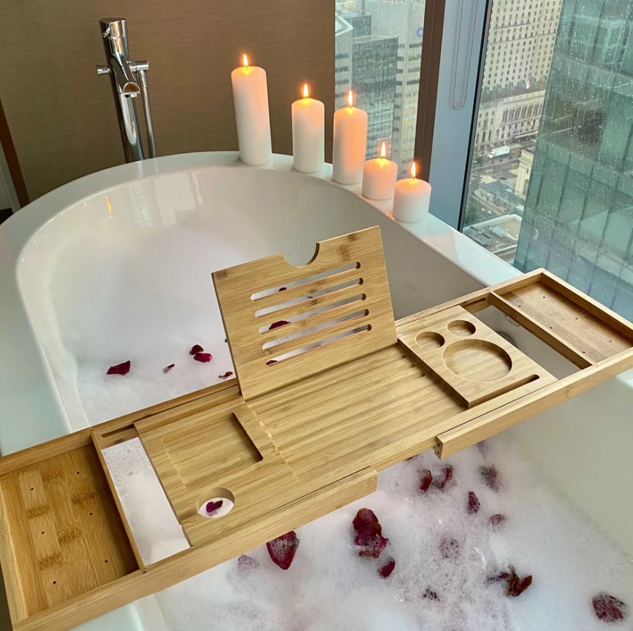 bathroom try in a bathtub, with candles around a rose petals below