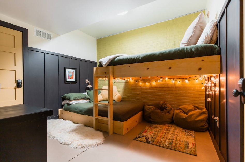 bedroom with a bunk bed, string lights with bean bags