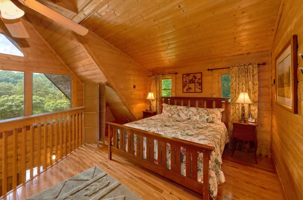 bedroom with a king sized bed, brown bedside table